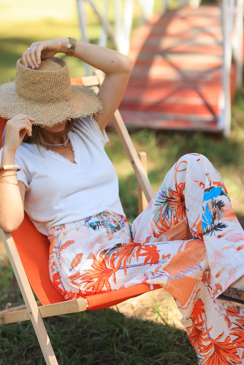 Ecru wide leg floaty pants with random colorful summer beach print