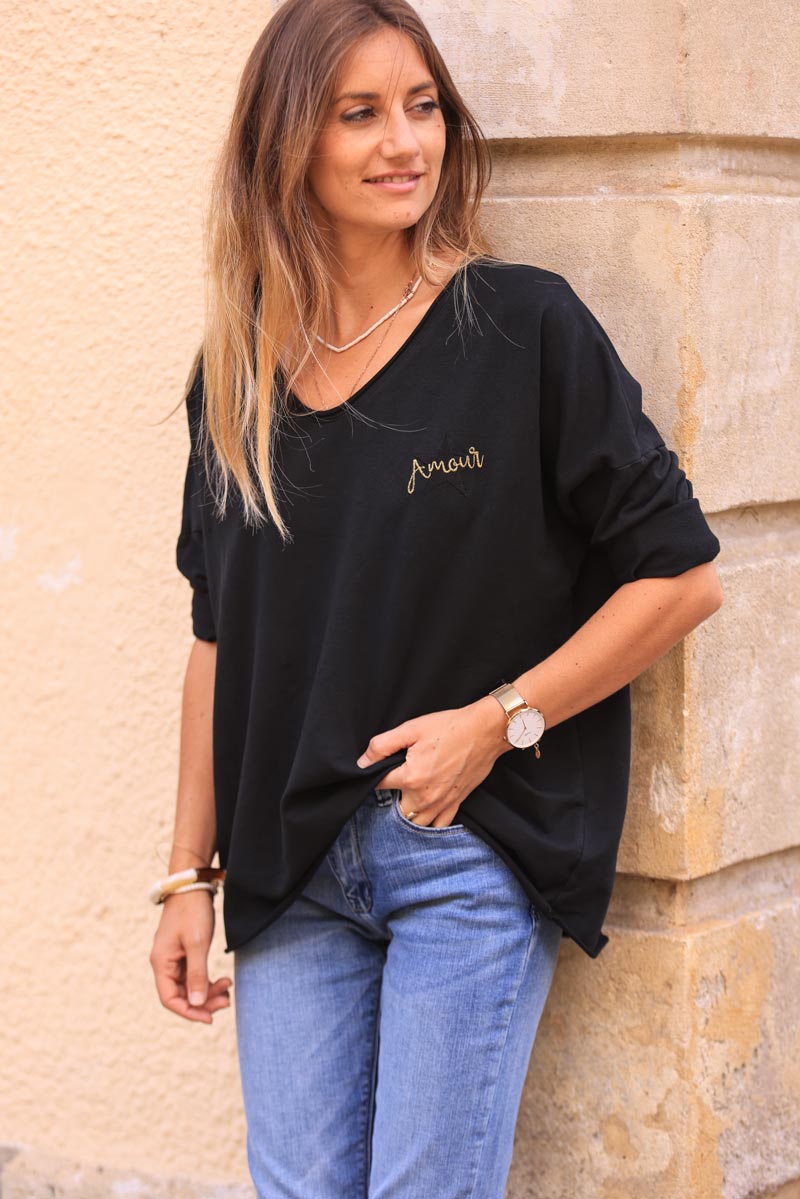 Black comfort sweater with gold star and 'amour' embroidery