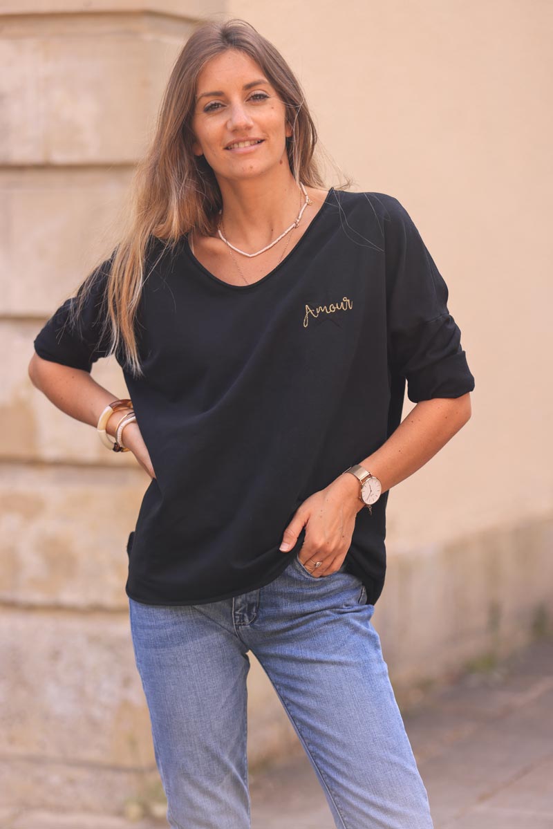 Black comfort sweater with gold star and 'amour' embroidery