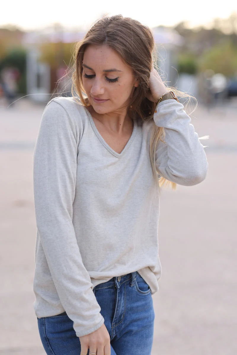 Beige lightweight sweater with silver glitter thread hems