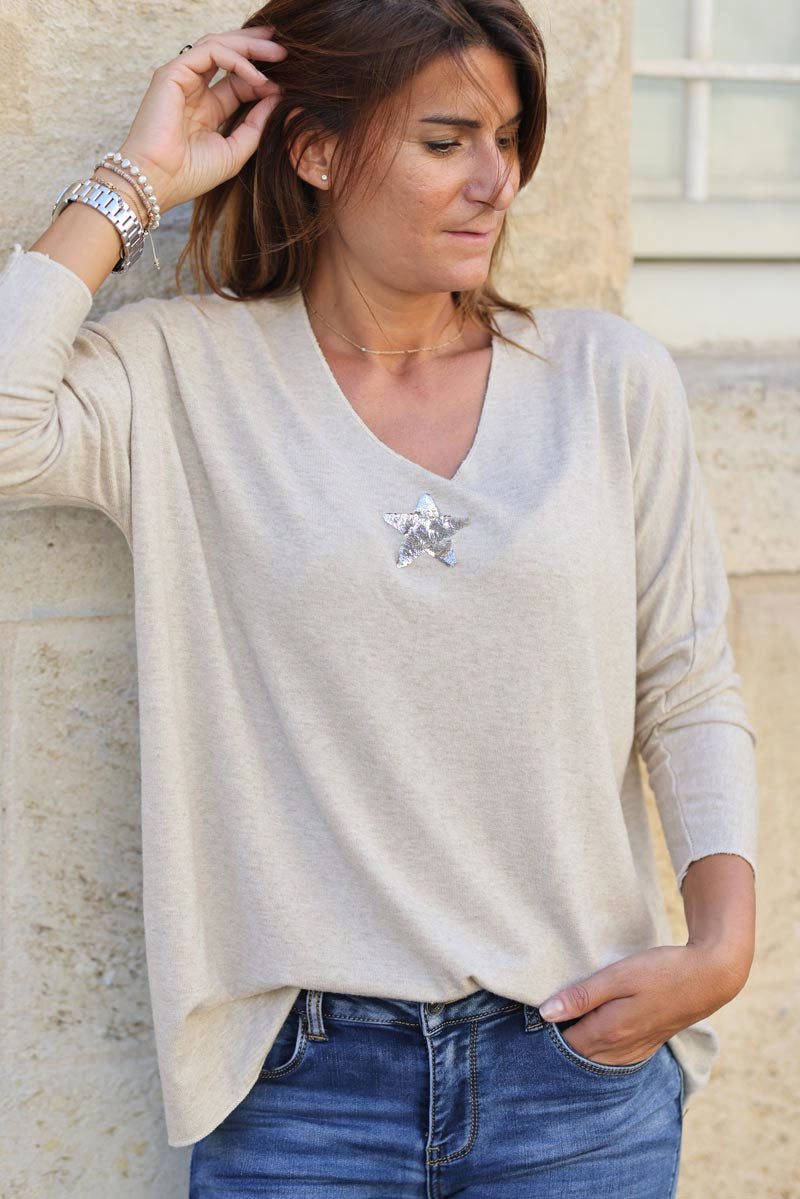 Beige v neck sweater with small sequin star