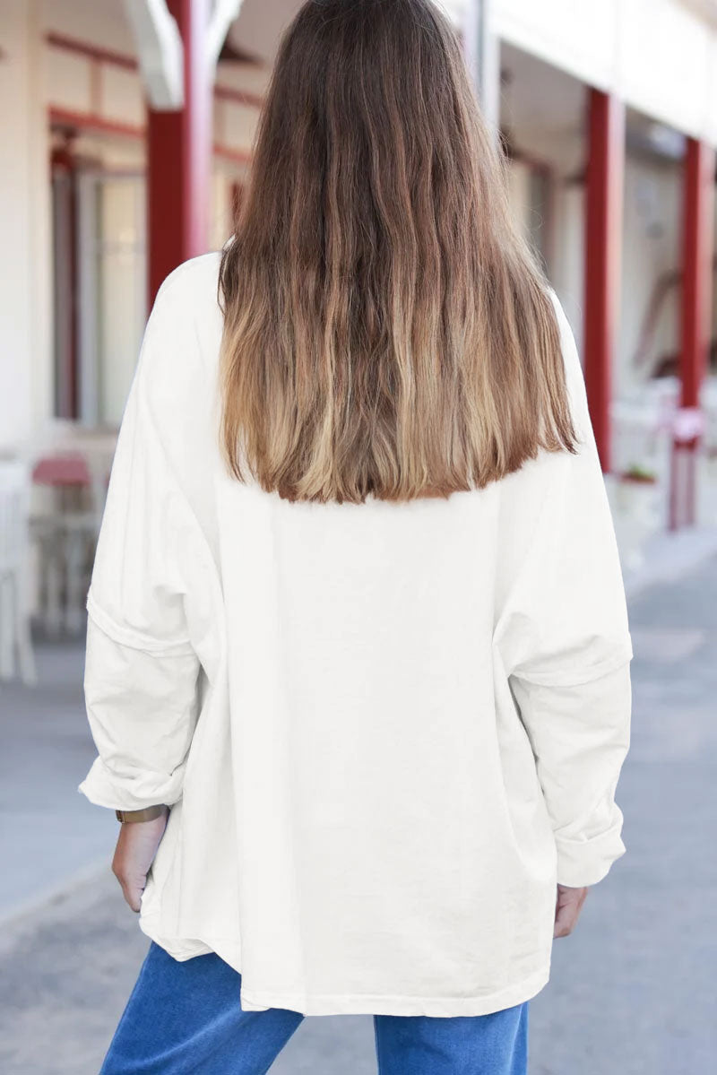 Suéter oversize de cuello redondo en algodón elástico de color blanco roto con costuras visibles