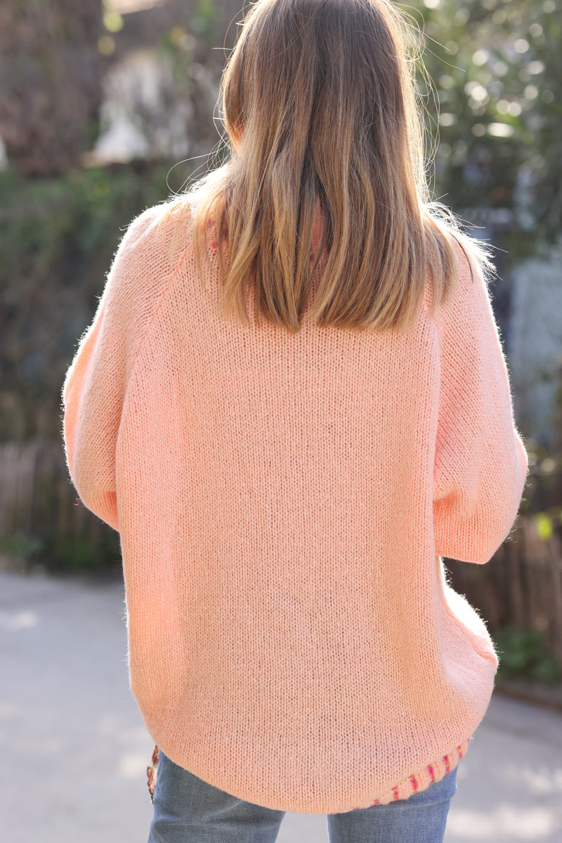 Soft knit sweater in salmon with funnel neck multicoloured stitching