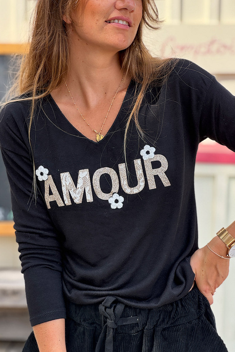 Pull noir en jersey doux Amour en paillettes dorées et fleurs bouclettes