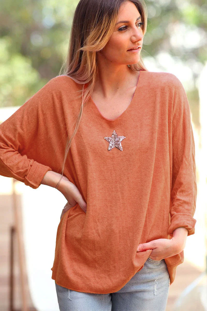 Orange v-neck sweater with small sequin star