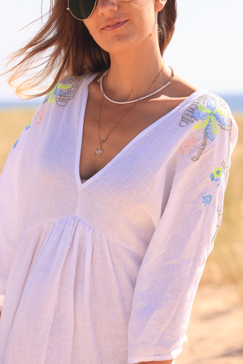 White maxi dress with batwing sleeves and colorful shoulder embroidery