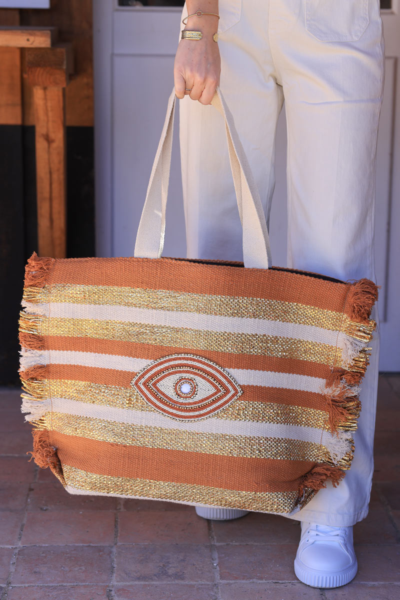 Woven tote bag in camel, beige and gold with beaded eye design