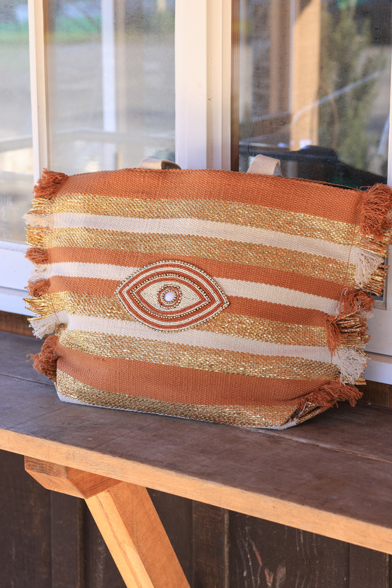 Woven tote bag in camel, beige and gold with beaded eye design