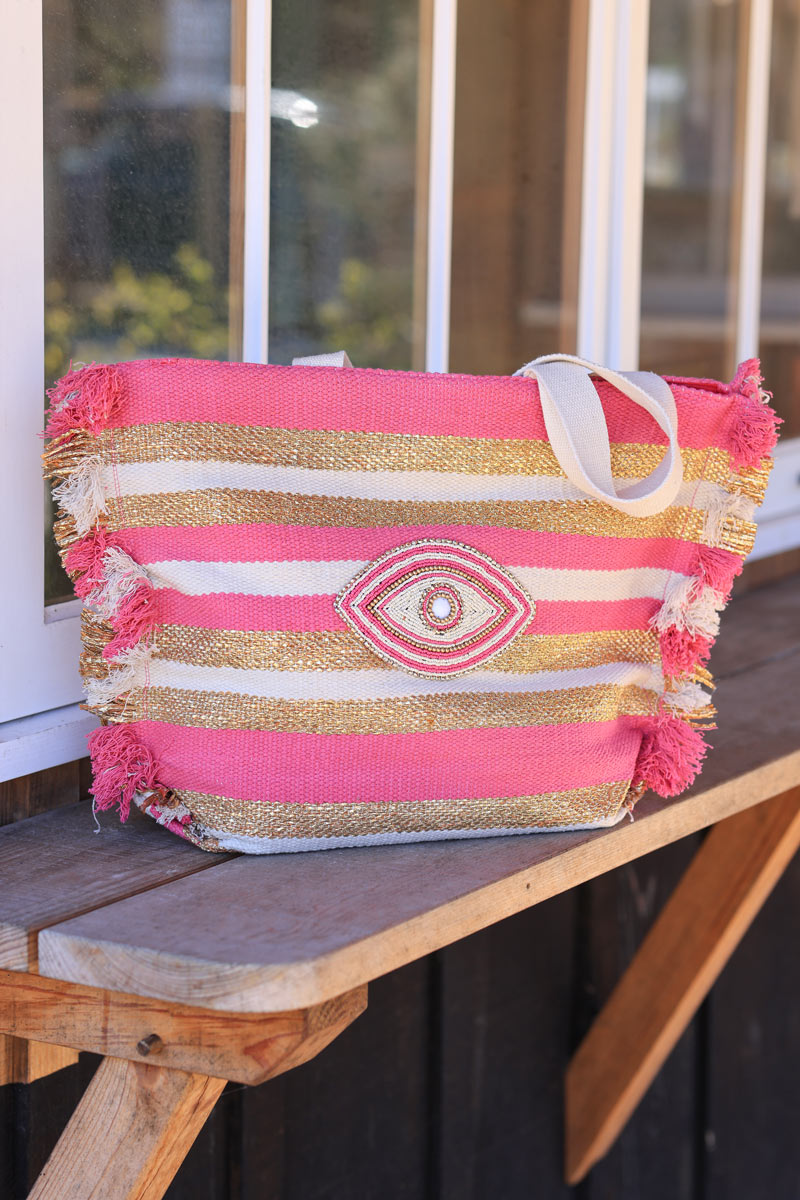 Woven tote bag in fuchsia, beige and gold with beaded eye design