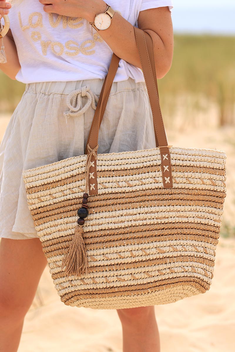 Ecru raffia basket bag with camel stripes and tassel handles
