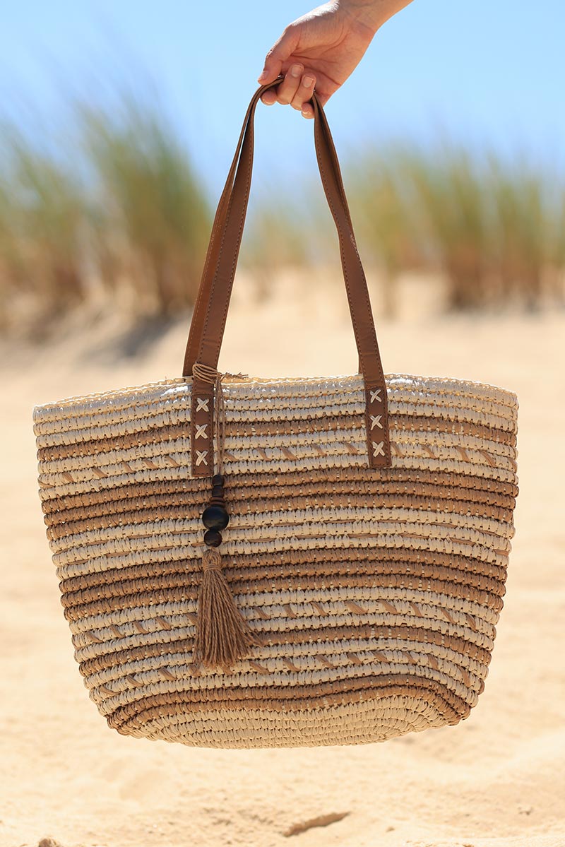Ecru raffia basket bag with camel stripes and tassel handles