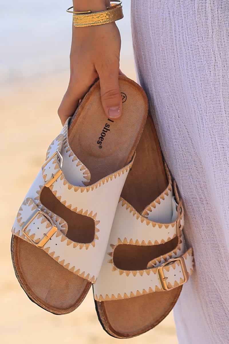 White faux leather sandals with double straps and gold embroidery