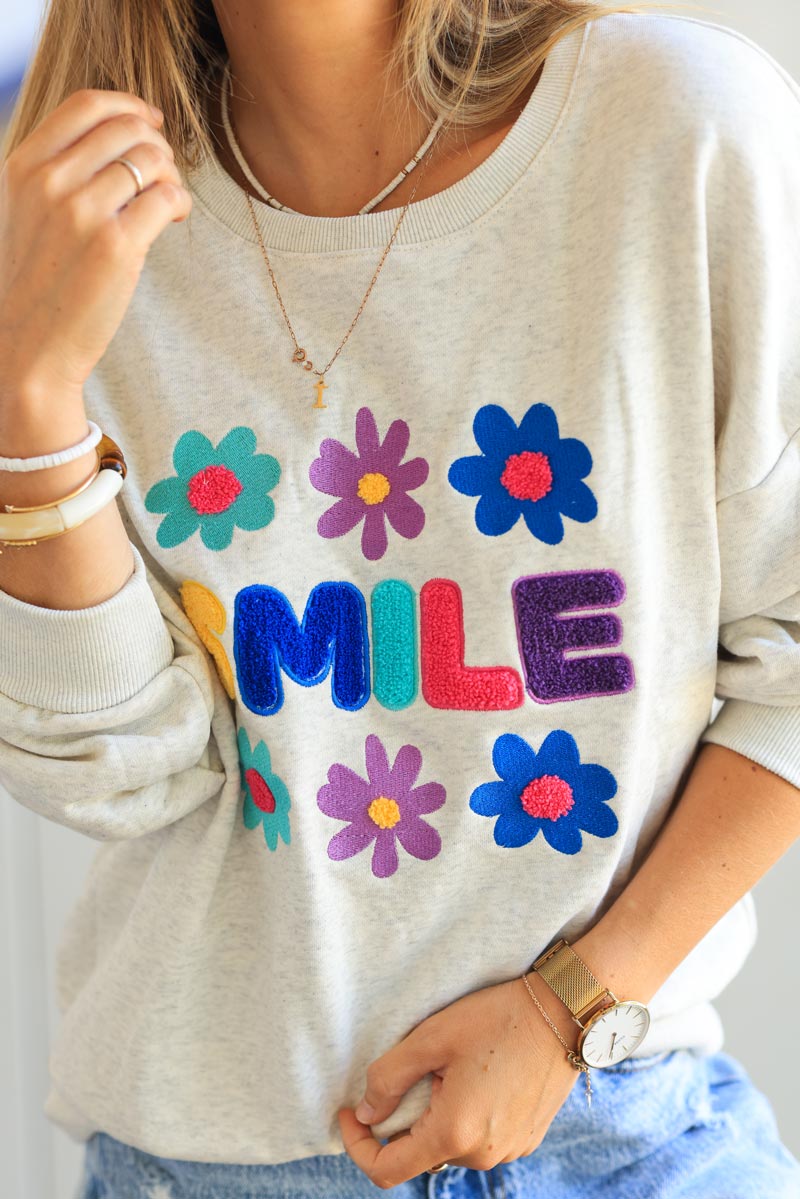 Heather gray sweater with colorful 'Smile' and flowers in boucle