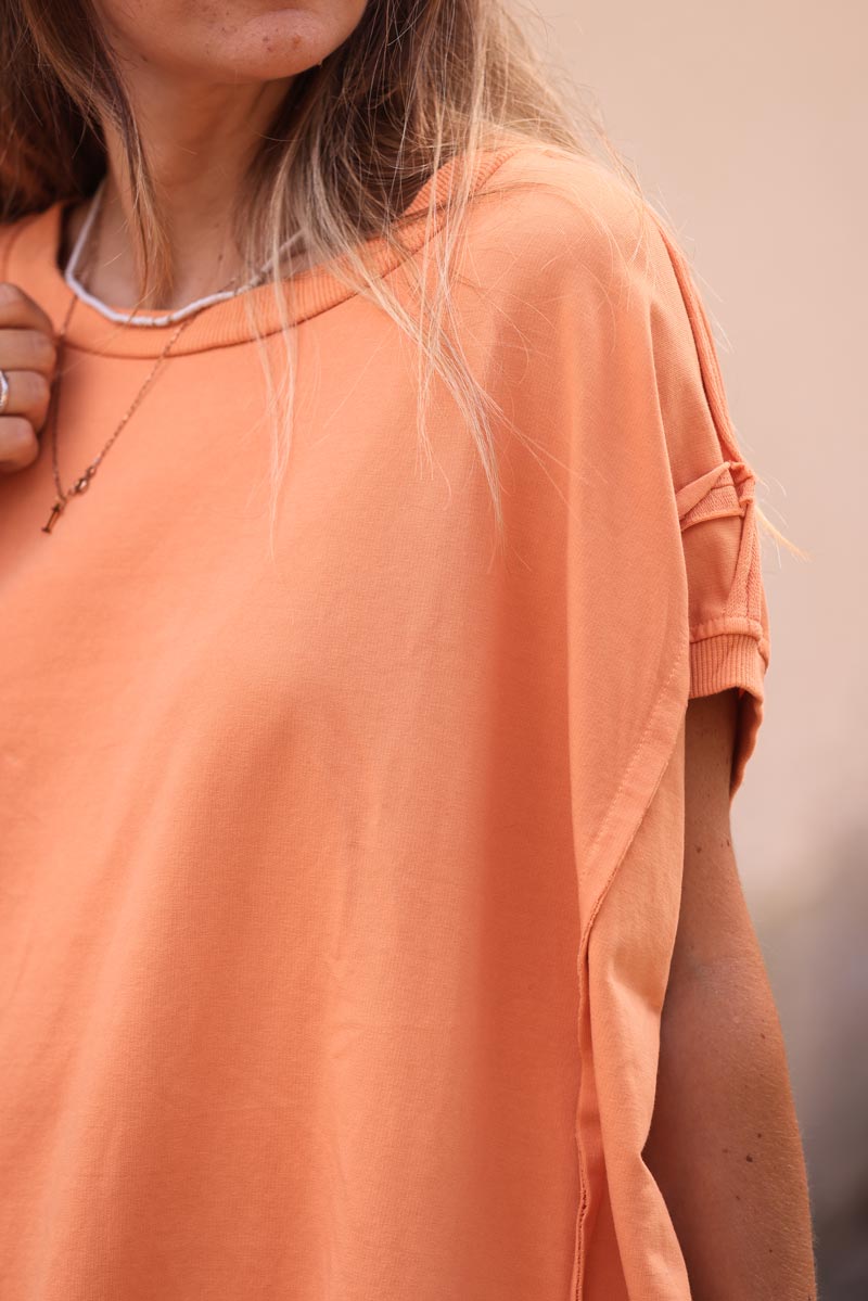 Light orange loose sleeveless sweater with seams detail