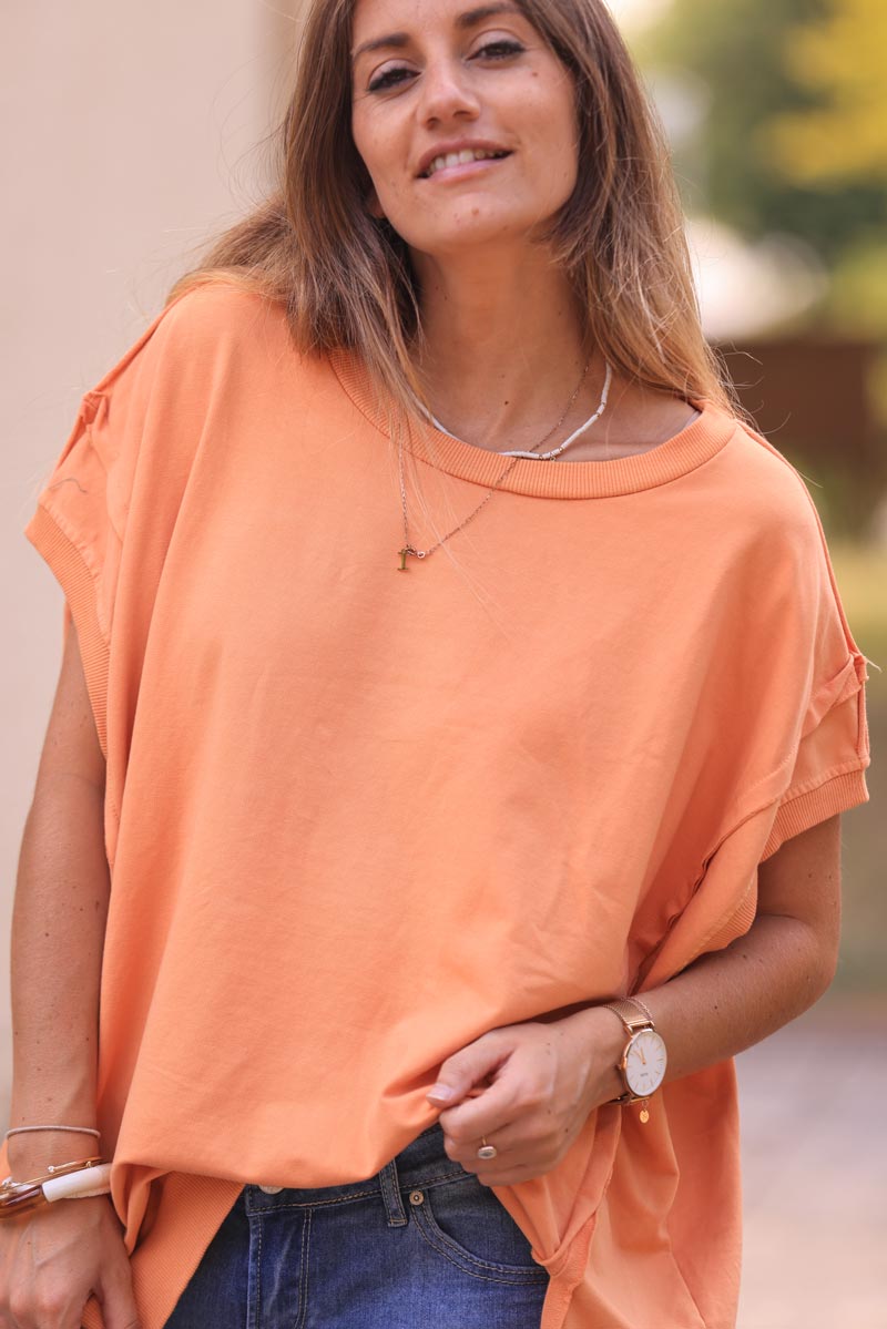 Light orange loose sleeveless sweater with seams detail