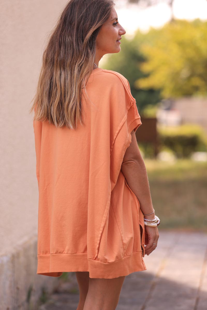 Light orange loose sleeveless sweater with seams detail