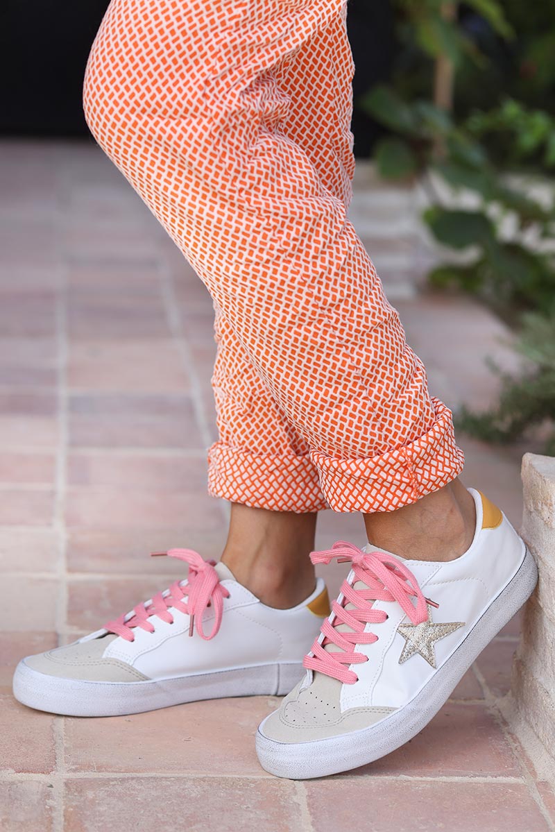 White sneakers with gold star and pink laces