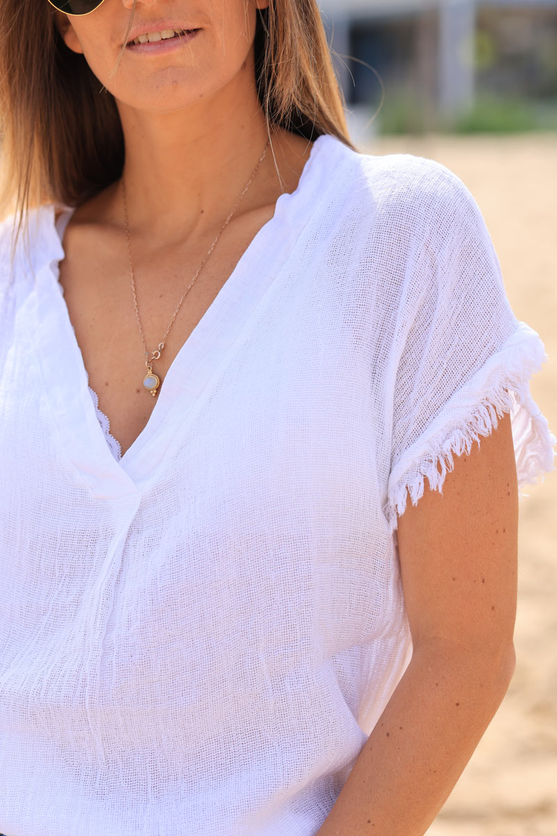 White cotton linen blend short sleeve blouse with fringed hems