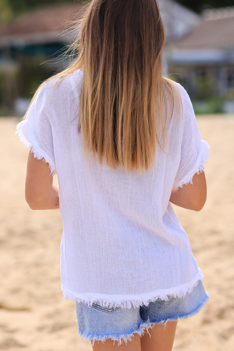 White cotton linen blend short sleeve blouse with fringed hems