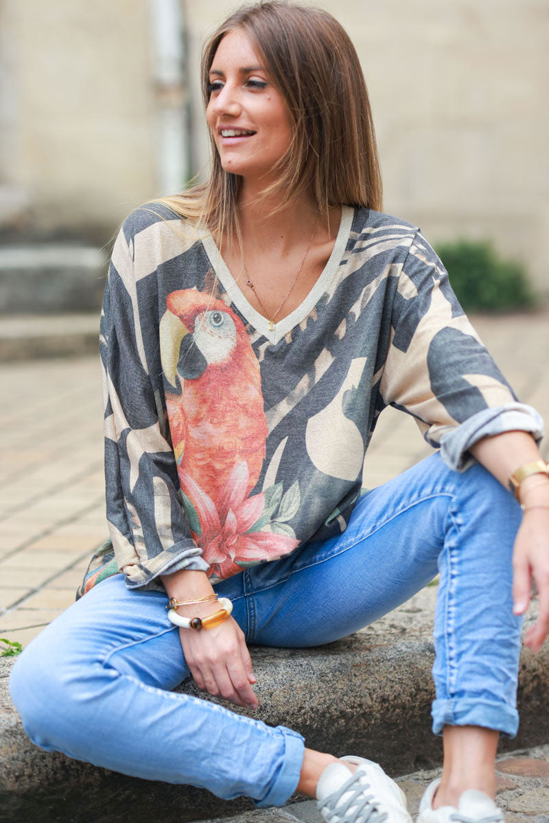 Shiny beige and black v-neck top with colorful ara parrot print