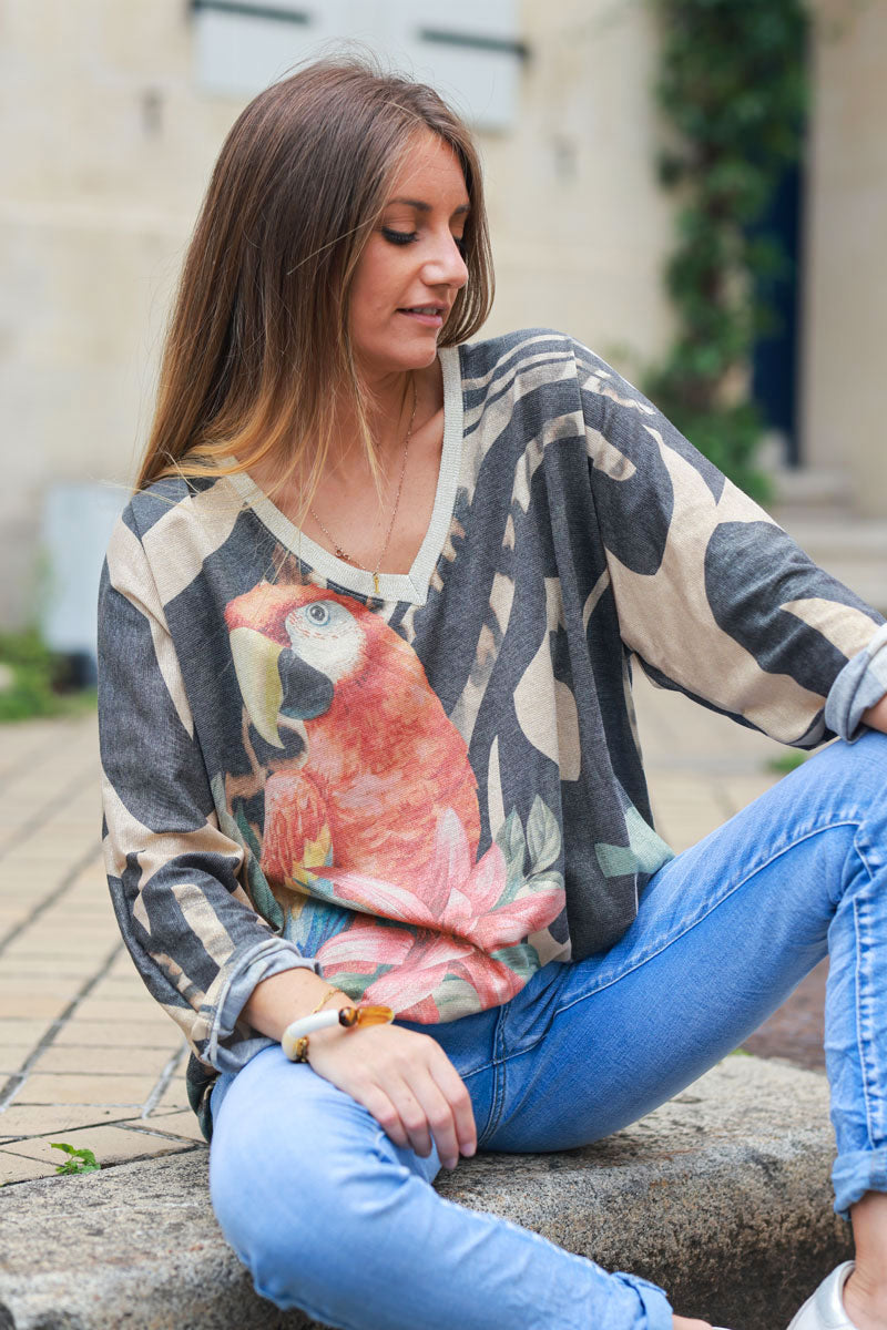 Shiny beige and black v-neck top with colorful ara parrot print