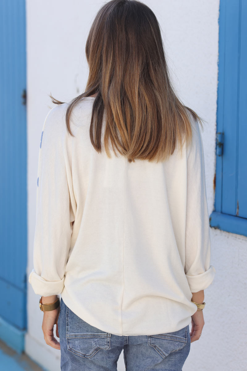 Ecru jersey jumper with daisy print in blue orange pastel tones