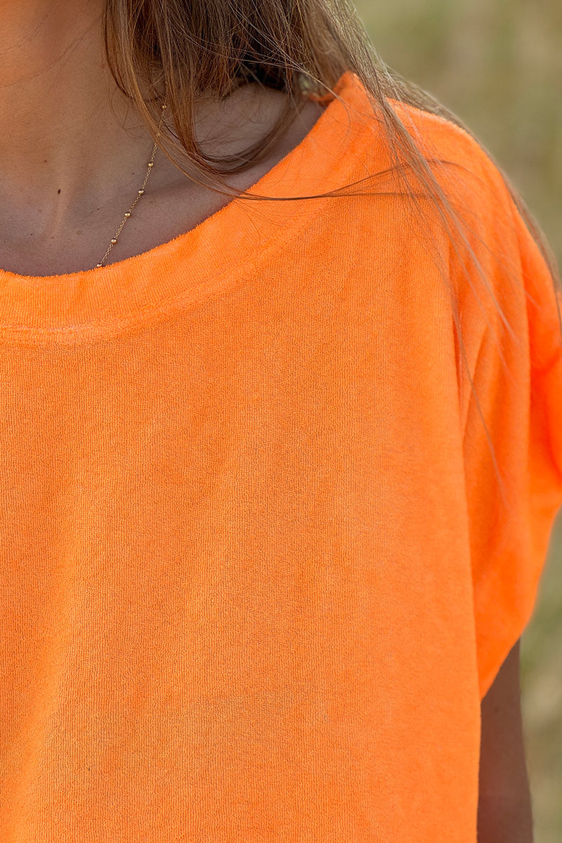Top holgado de color naranja fluorescente en suave tejido de rizo