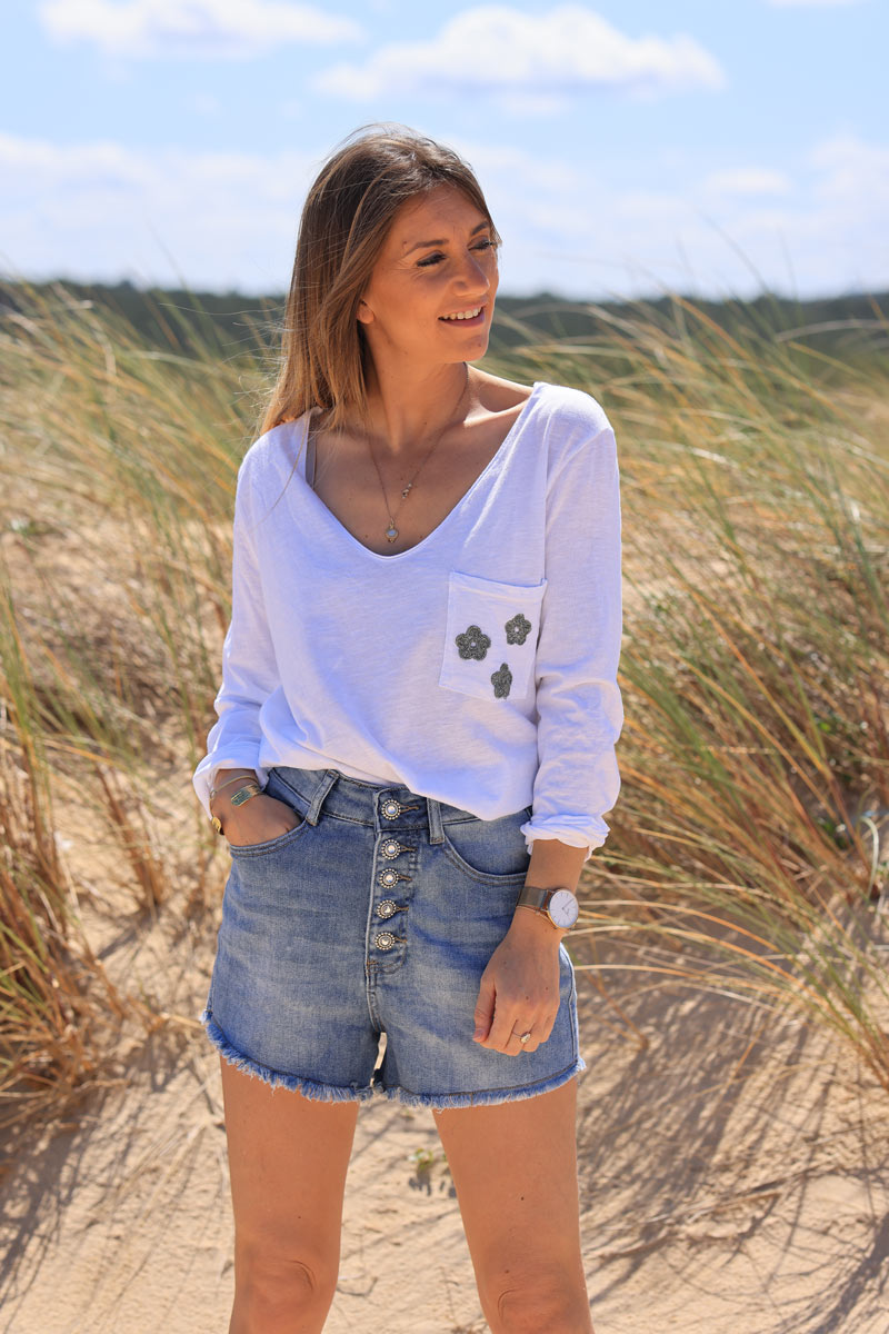 White long sleeve top with khaki embroidered pocket flowers