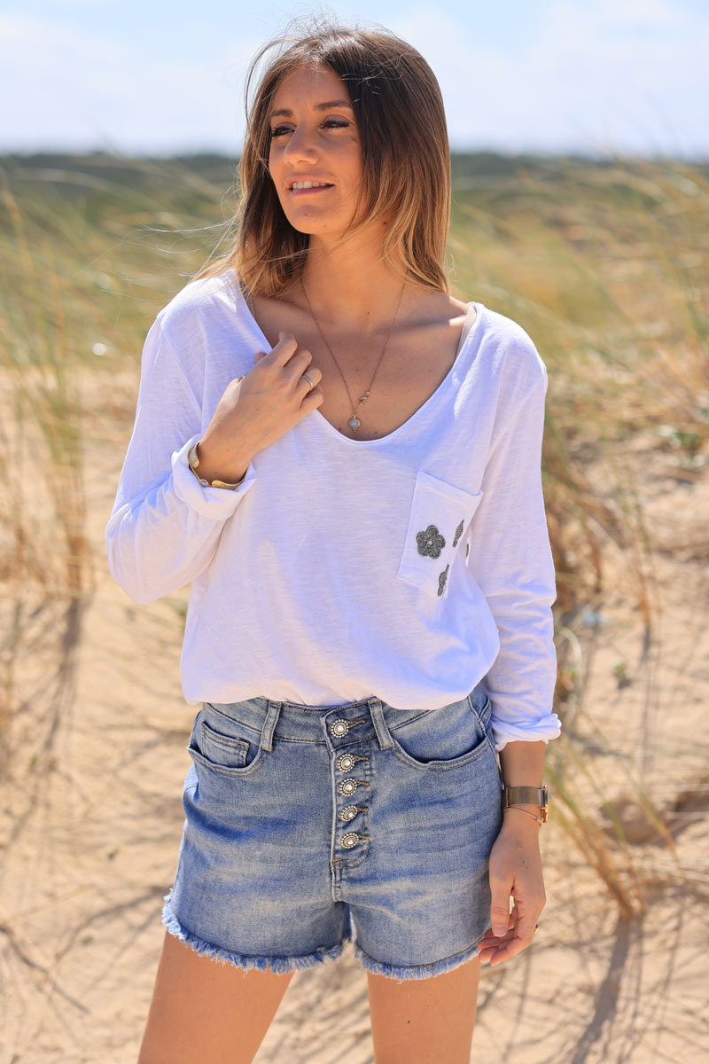 White long sleeve top with khaki embroidered pocket flowers