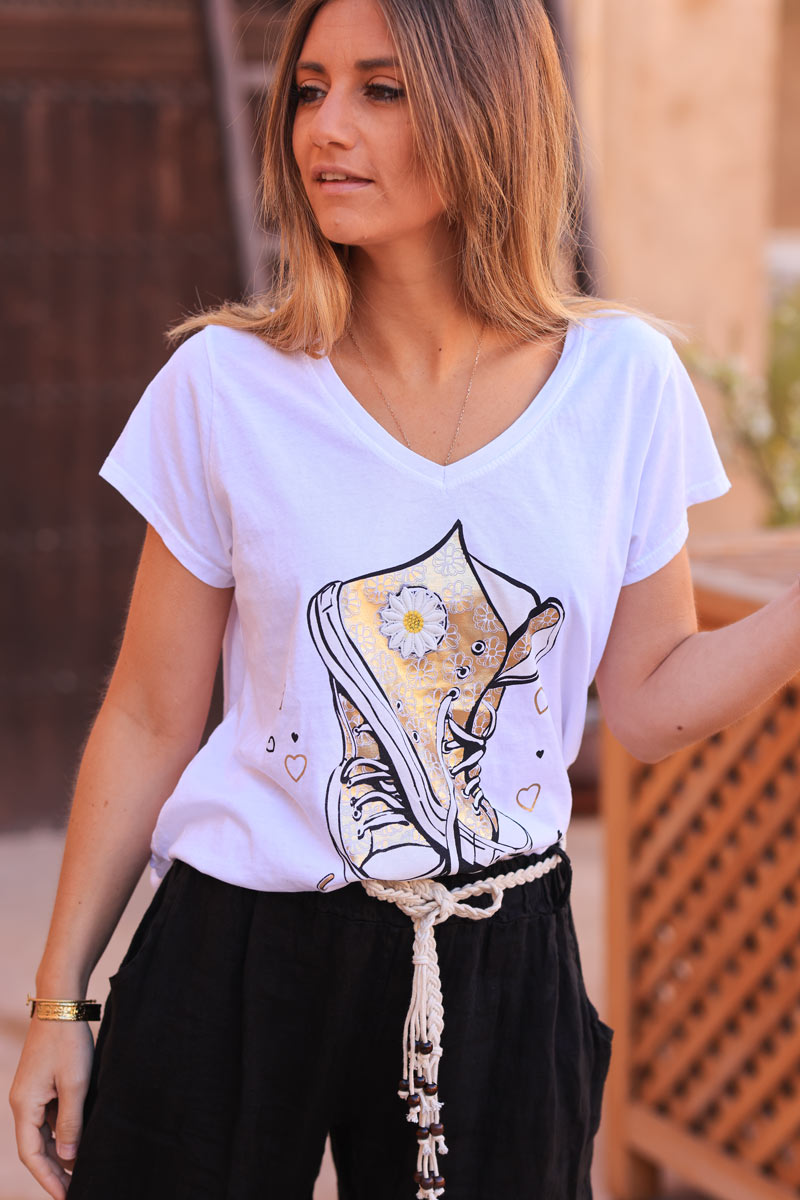 White cotton t-shirt with gold sneaker design and embrodered daisy