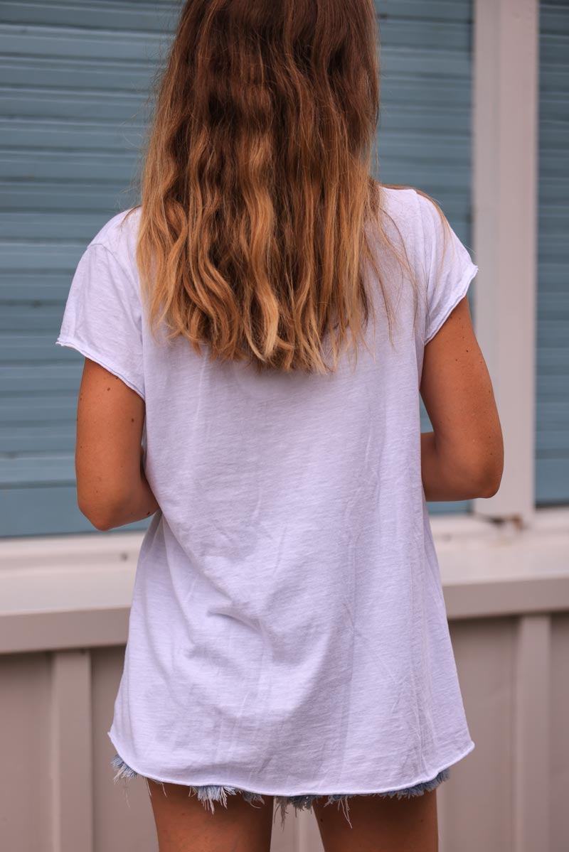 White cotton t-shirt with celadon green fish design in boucle