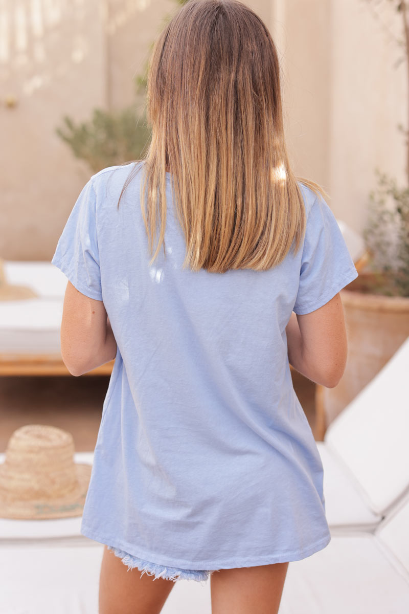 Sky blue cotton t-shirt with glitter arrow and 'PEACE' in boucle