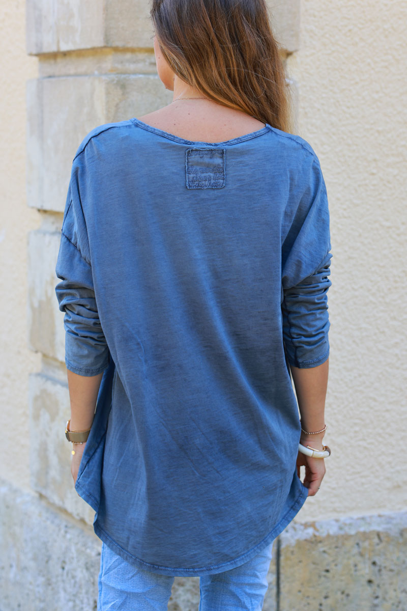 Faded blue long sleeve top with embroidered back patch