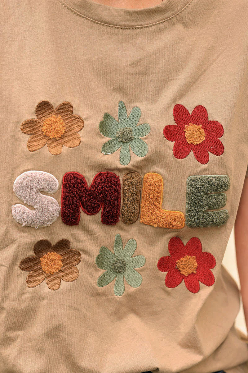 Camel loose t-shirt with colorful ‘SMILE’ and flowers in boucle