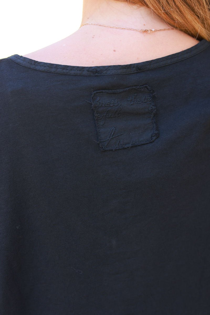 Black long sleeve top with embroidered back patch