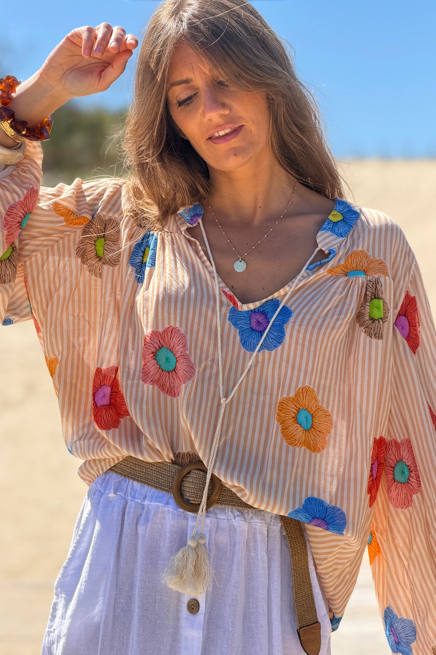 Floaty semi-sheer blouse with orange stripes and colourful flower print
