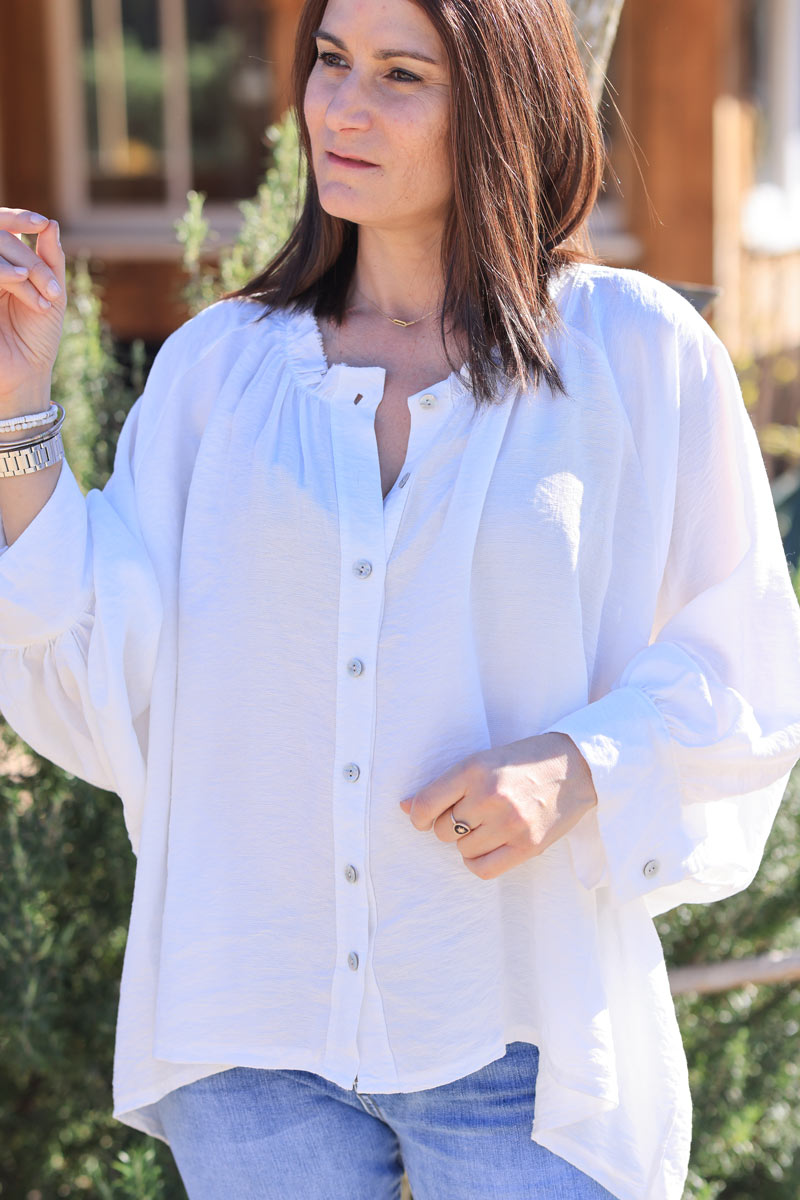 White oversized blouse with frills and batwing sleeves