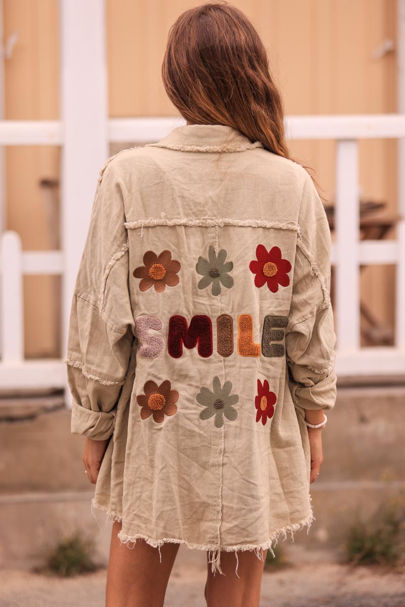 Beige denim jacket with 'smile' and flower embroidery