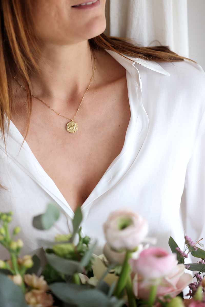 Gold necklace with taurus zodiac pendant