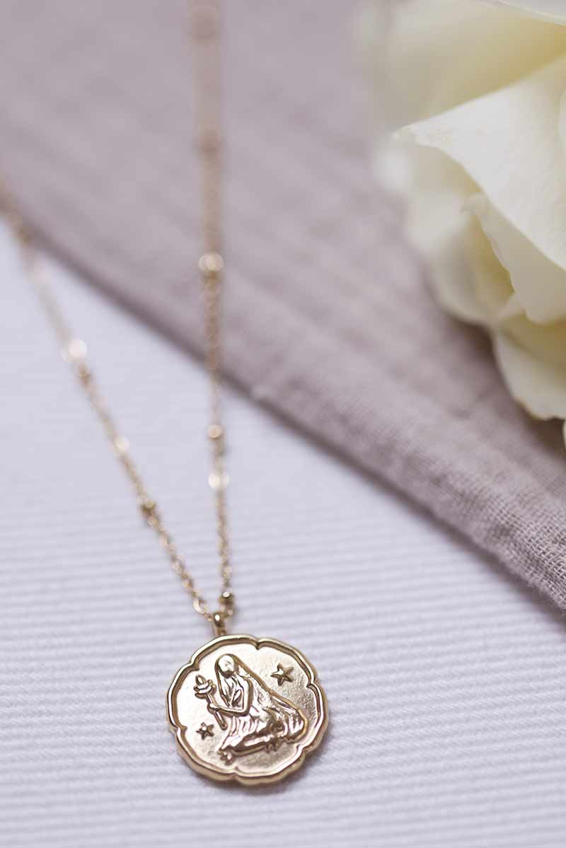 Gold necklace with virgo zodiac pendant