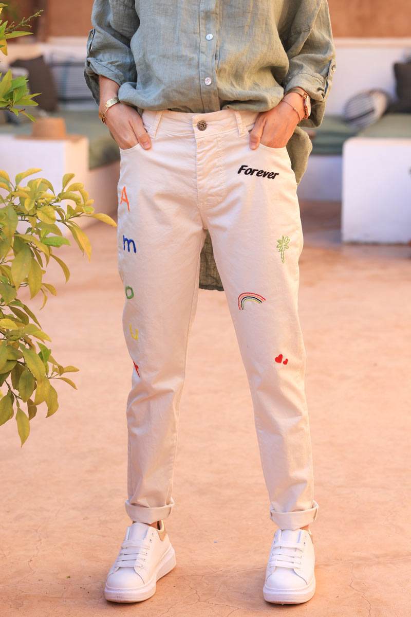 Ecru stretch pants with colourful embroidered designs