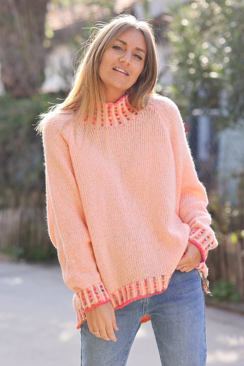 Soft knit sweater in salmon with funnel neck multicoloured stitching