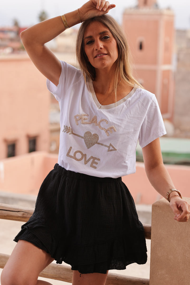 White cotton t-shirt with glitter arrow and 'PEACE' in boucle